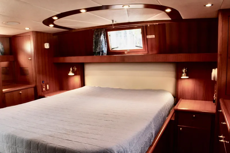 Slide: The Image of Luxurious bedroom interior of 2007 Jefferson 45 Motor Yacht with wood paneling and ambient lighting. - 20