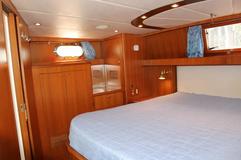 Slide: The Image of Luxurious cabin interior of 2007 Jefferson 45 Motor Yacht with wood paneling and cozy bed. - 21