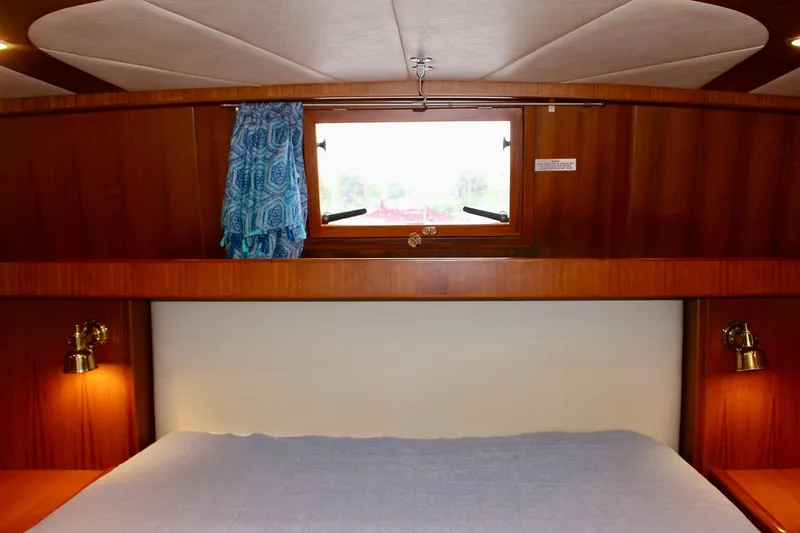 Slide: The Image of Interior cabin of 2007 Jefferson 45 Motor Yacht with wooden paneling and window. - 23