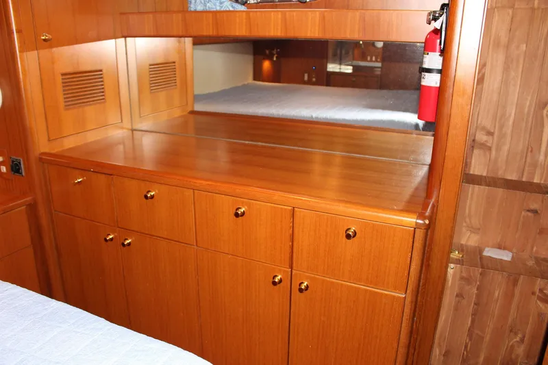 Slide: The Image of Wooden cabinetry and mirror inside a 2007 Jefferson 45 Motor Yacht cabin. - 24