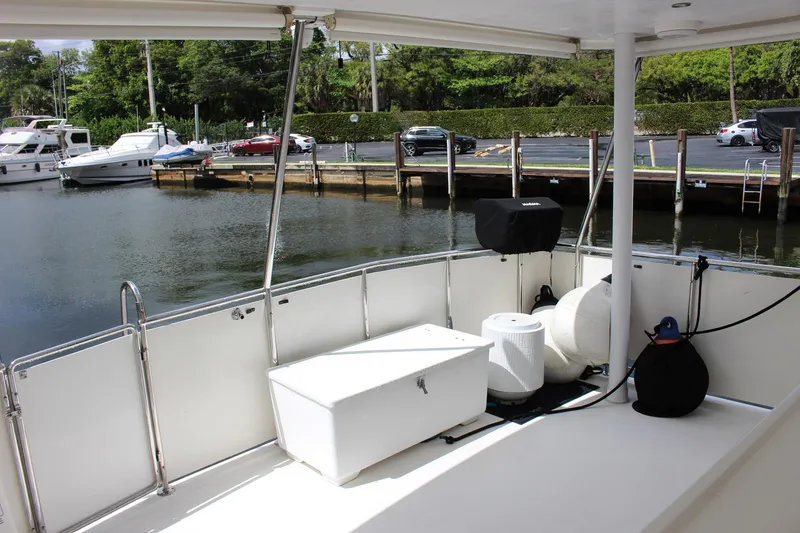 Slide: The Image of 2007 Jefferson 45 Motor Yacht deck view at marina, featuring storage and seating. - 5