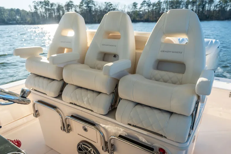 Slide: The Image of Three luxurious, cushioned seats on a Grady-White 321 CE boat, overlooking calm waters. - 5
