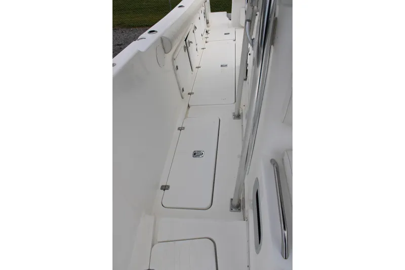 Slide: The Image of Century 3100 boat deck, 2000 model, featuring storage compartments and stainless steel railings. - 19