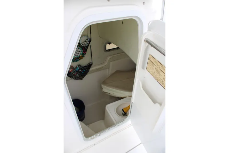 Slide: The Image of Interior cabin view of a 2000 Century 3100 boat, featuring storage and seating. - 20