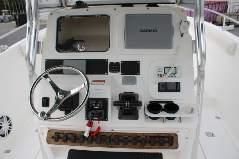 Slide: The Image of Century 3100 boat dashboard with steering wheel, Garmin display, and control panel, year 2000. - 21
