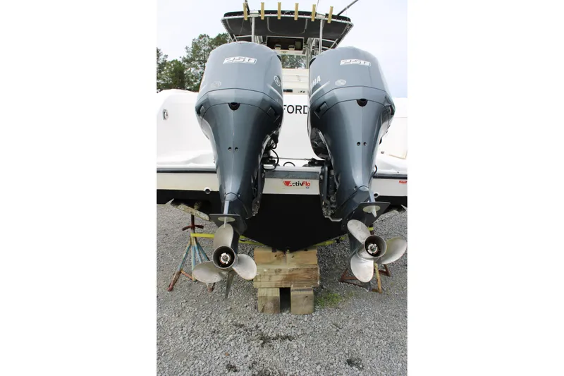 Slide: The Image of Twin Yamaha outboard motors on a 2000 Century 3100 boat, displayed on a gravel surface. - 7