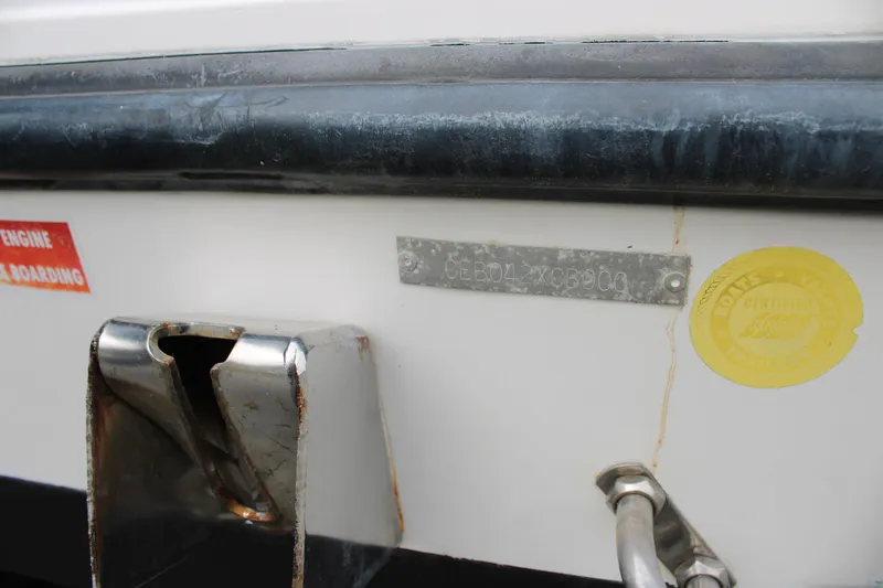 Slide: The Image of Close-up of a 2000 Century 3100 boat's identification plate and certification sticker. - 9