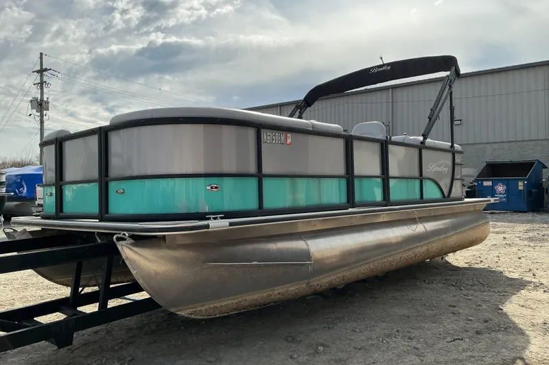 The Image of 2024 Bentley Pontoons 200 Navigator on trailer, parked outdoors under cloudy sky. - 1