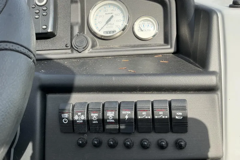 Slide: The Image of Control panel of a 2024 Bentley Pontoons 200 Navigator with switches and gauges. - 11