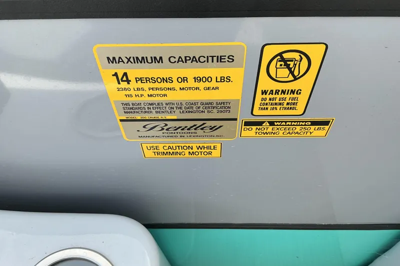 Slide: The Image of 2024 Bentley Pontoons 200 Navigator capacity and safety warning labels. - 12