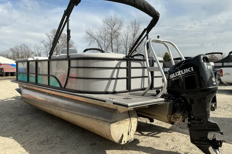 Slide: The Image of 2024 Bentley Pontoons 200 Navigator with Suzuki engine, parked outdoors on gravel. - 3