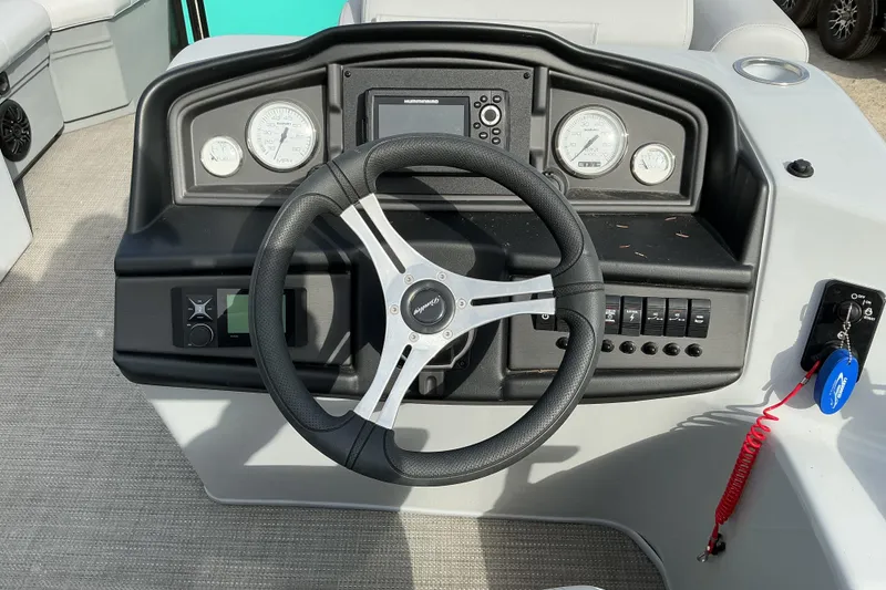 Slide: The Image of 2024 Bentley Pontoons 200 Navigator dashboard with steering wheel and control panel. - 5
