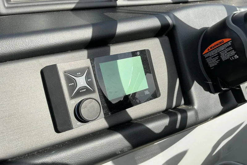 Slide: The Image of 2024 Bentley Pontoons 200 Navigator dashboard with JBL audio system and control panel. - 6