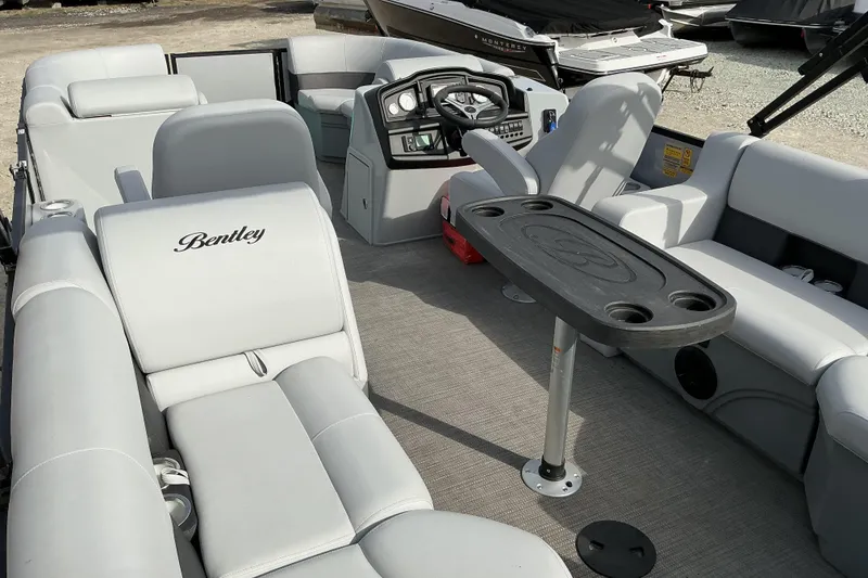 Slide: The Image of 2024 Bentley Pontoons 200 Navigator interior with plush seating and steering console. - 7