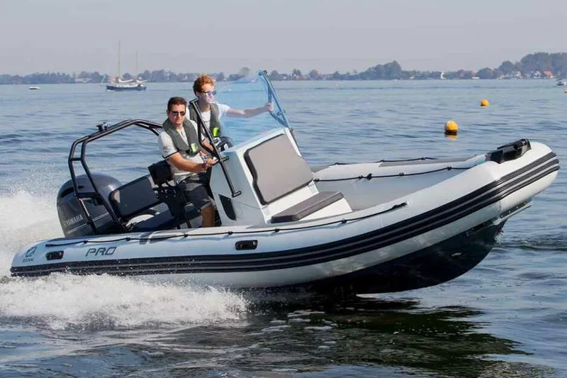 Slide: The Image of Manufacturer Provided Image: 2026 Zodiac Pro 6.5 boat cruising on water. - 1