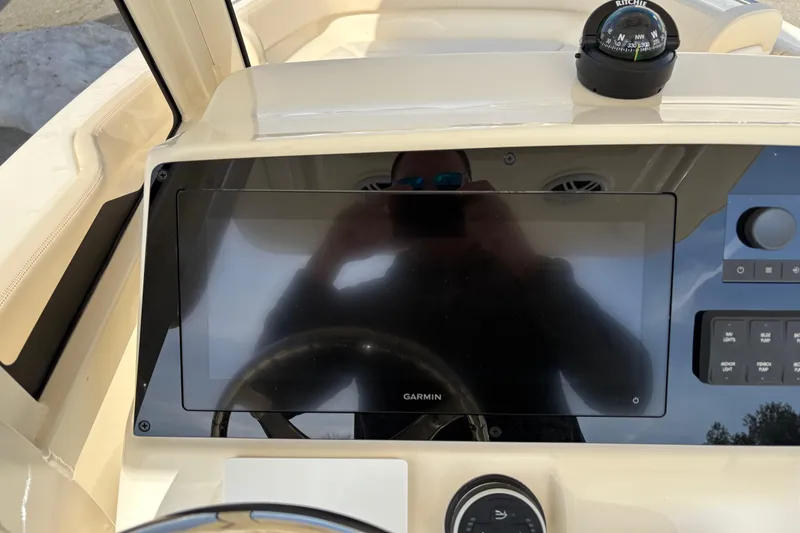 Slide: The Image of Dashboard of 2026 Scout 220 XSF boat with Garmin display and compass. - 10