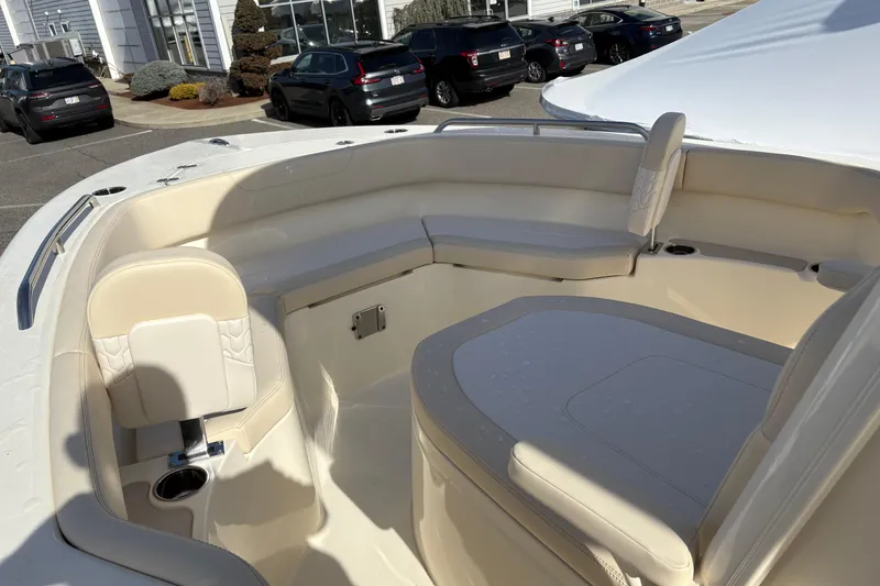 Slide: The Image of 2026 Scout 220 XSF boat interior with beige seating and cup holders. - 13