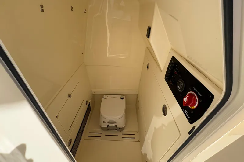 Slide: The Image of 2026 Scout 220 XSF boat interior with compact toilet and control panel. - 14