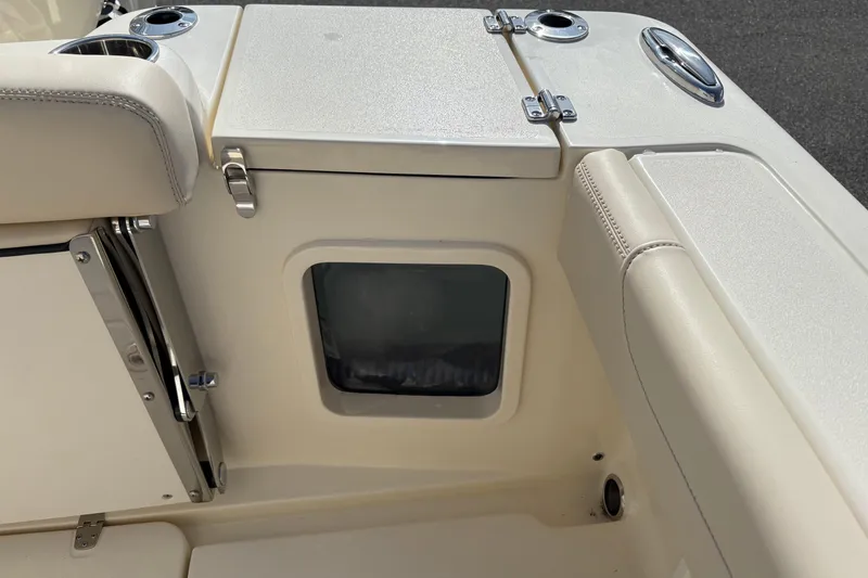 Slide: The Image of Interior view of a 2026 Scout 220 XSF boat, featuring seating and storage compartments. - 6
