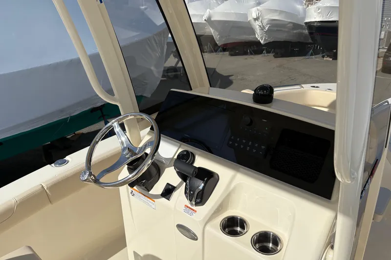 Slide: The Image of 2026 Scout 220 XSF boat dashboard with steering wheel and controls. - 9