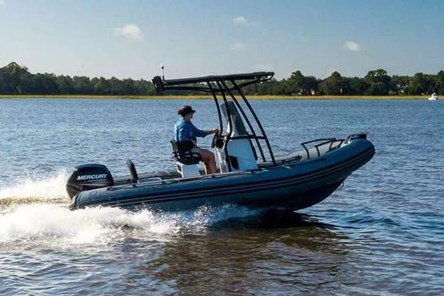 Slide: The Image of Manufacturer Provided Image: Zodiac Pro 5.5 boat 2026 on water with driver. - 1