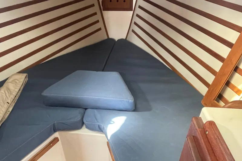 Slide: The Image of Interior cabin of a 1987 Com-Pac 27 sailboat with blue cushions. - 21