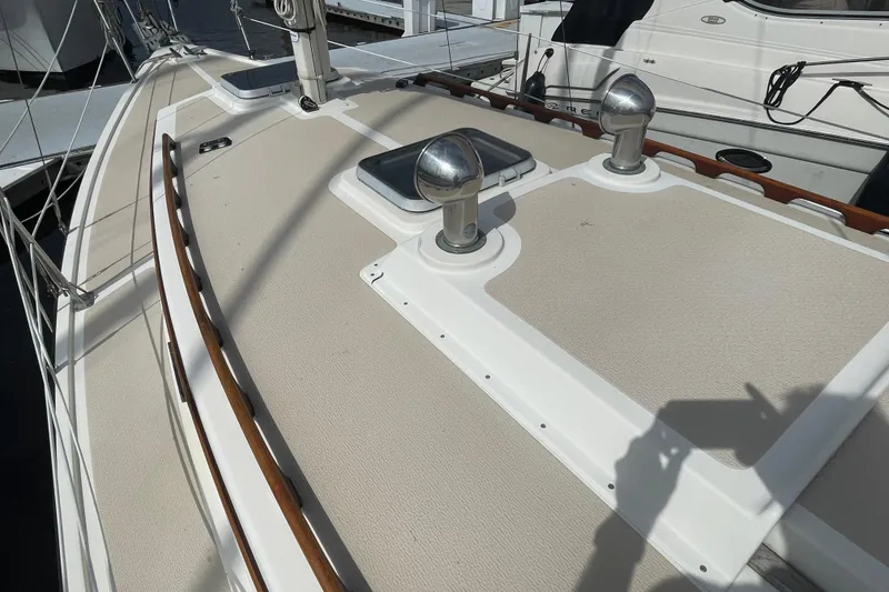 Slide: The Image of Deck of 1987 Com-Pac 27 sailboat with stainless steel fittings and wooden trim. - 5