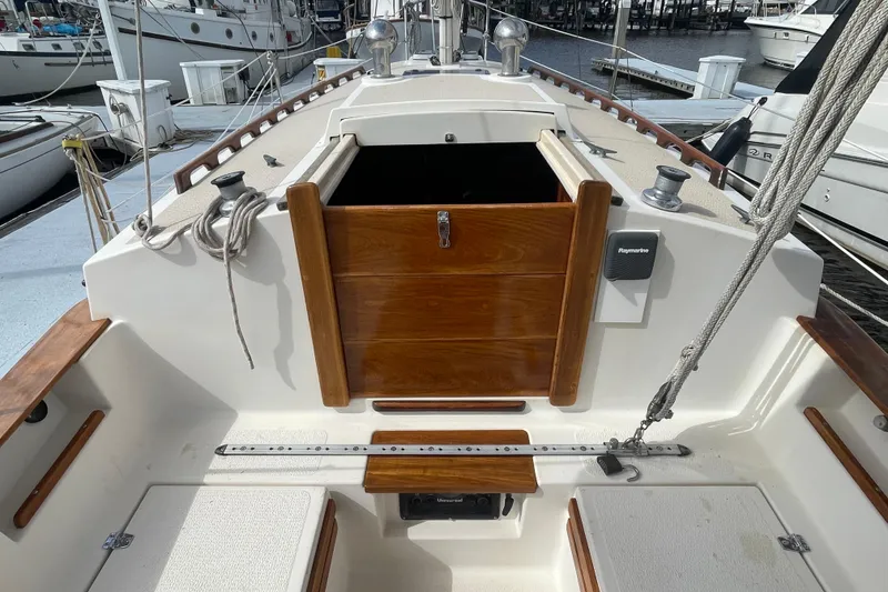 Slide: The Image of 1987 Com-Pac 27 sailboat cockpit with wooden hatch and nautical equipment. - 7
