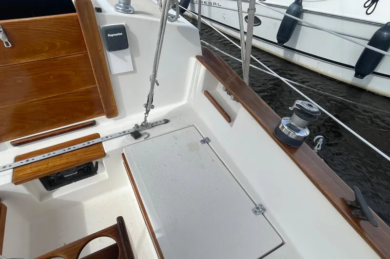 Slide: The Image of Cockpit of 1987 Com-Pac 27 sailboat with wooden trim and Raymarine equipment. - 8