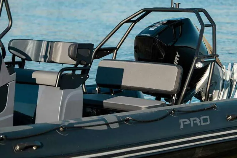 Slide: The Image of Manufacturer Provided Image: 2026 Zodiac Pro 7 boat interior with seating and motor. - 3
