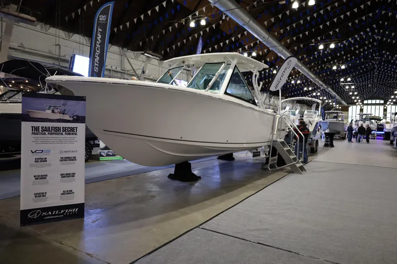 The Image of 2025 Sailfish 276 DC boat displayed at an indoor exhibition, showcasing its sleek design. - 0