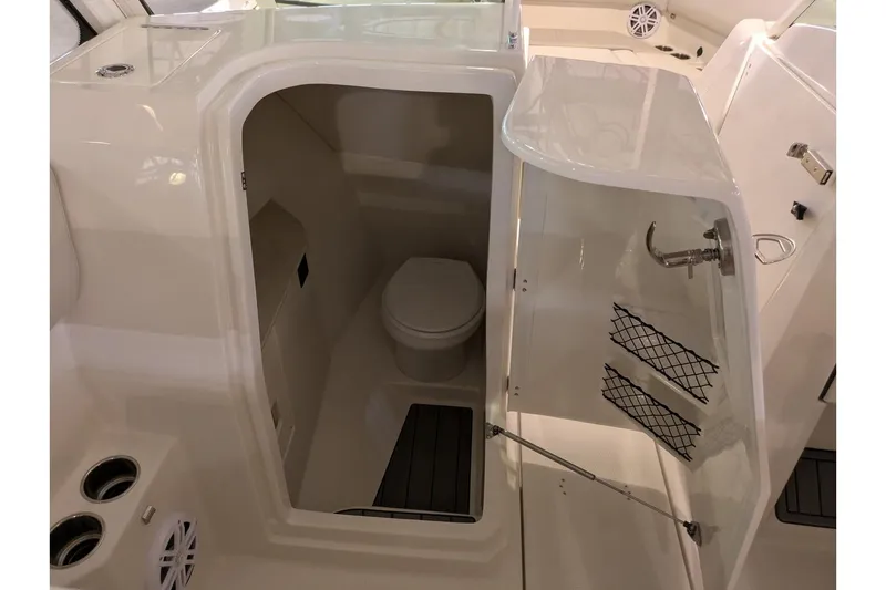 Slide: The Image of 2025 Sailfish 276 DC boat interior with compact marine toilet and storage. - 14
