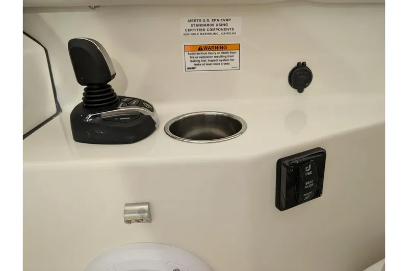 Slide: The Image of 2025 Sailfish 276 DC boat control panel with joystick and warning label. - 17
