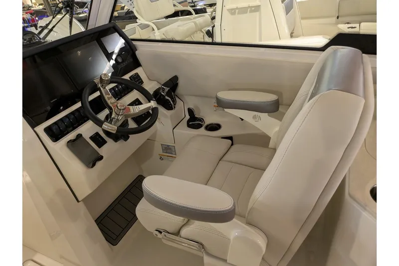 Slide: The Image of Helm of 2025 Sailfish 276 DC boat with modern steering and controls. - 18