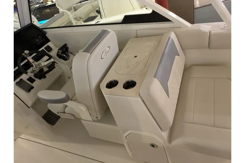 Slide: The Image of Interior of 2025 Sailfish 276 DC boat with white seating and steering console. - 19