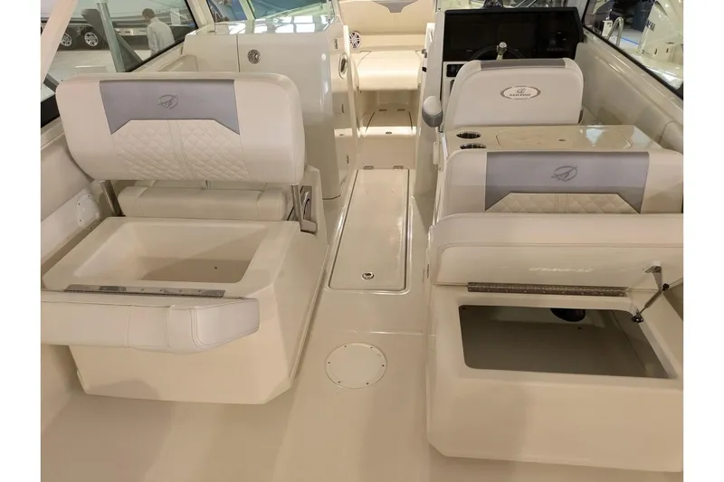 Slide: The Image of 2025 Sailfish 276 DC boat interior with white seating and modern dashboard. - 20