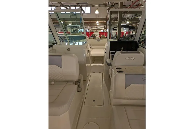 Slide: The Image of Interior view of 2025 Sailfish 276 DC boat, showcasing seating and helm area. - 21