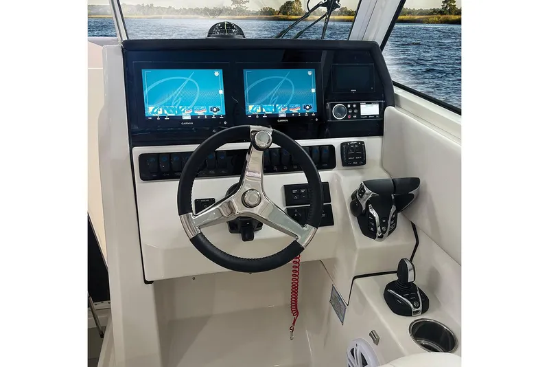 Slide: The Image of Manufacturer Provided Image: 2025 Sailfish 276 DC boat dashboard with dual screens and steering wheel. - 7
