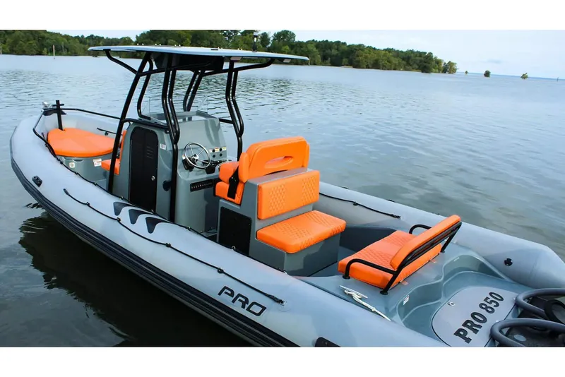 Slide: The Image of Manufacturer Provided Image: 2026 Zodiac Pro 850 boat with orange seats on a lake. - 1