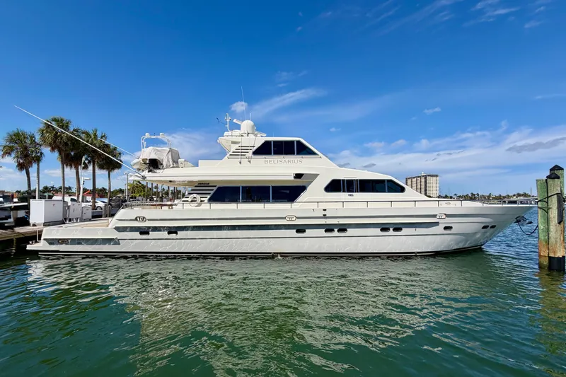 The Image of Luxurious Horizon 92 yacht docked in sunny marina with palm trees and clear blue sky. - 0
