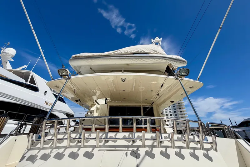 Slide: The Image of Luxury Horizon 92 yacht docked under clear blue sky, showcasing sleek design and modern features. - 10