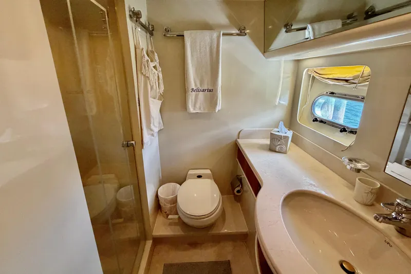 Slide: The Image of Luxurious yacht bathroom with shower, toilet, and sink, featuring elegant fixtures and a porthole window. - 101