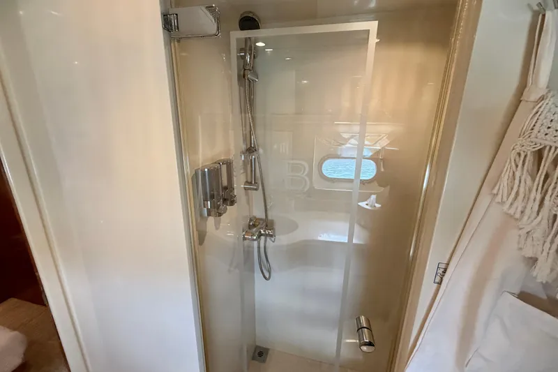 Slide: The Image of Shower area in Horizon 92 yacht with glass door and chrome fixtures. - 102