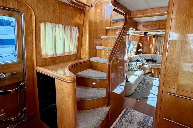 Slide: The Image of Luxurious Horizon 92 yacht interior with wooden staircase and elegant living area. - 105