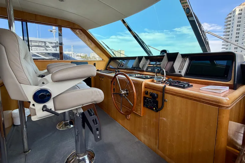 Slide: The Image of Luxurious Horizon 92 yacht helm with leather seats and advanced navigation equipment. - 106