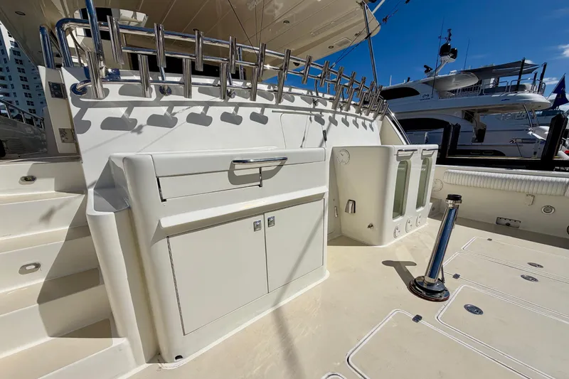 Slide: The Image of Luxury Horizon 92 yacht deck with fishing rod holders and storage compartments. - 11