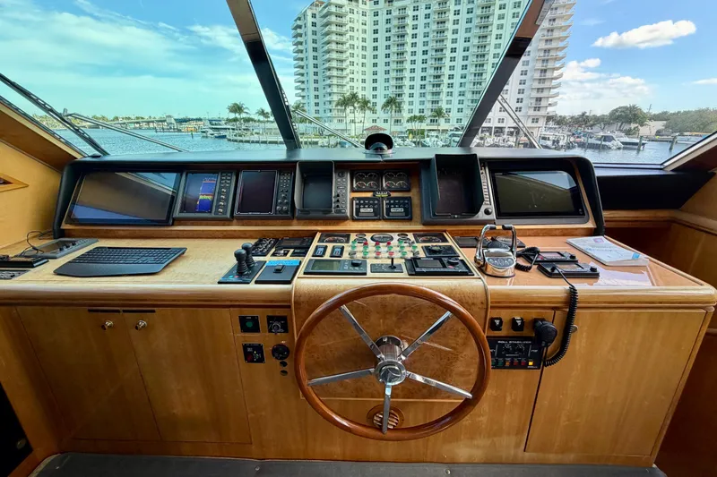 Slide: The Image of Helm of Horizon 92 yacht with navigation controls and waterfront view. - 110