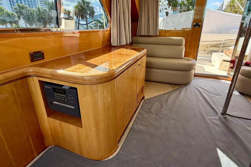Slide: The Image of Luxurious Horizon 92 yacht interior with wood cabinetry, plush seating, and large windows. - 118