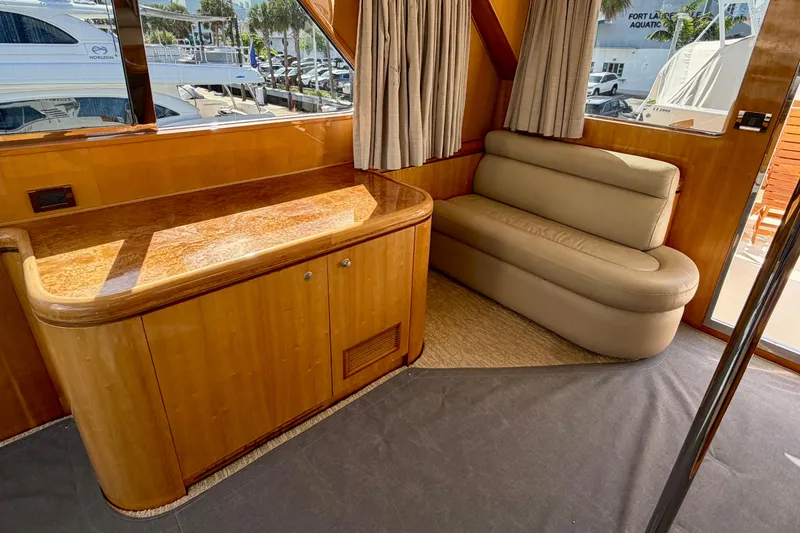 Slide: The Image of Luxurious Horizon 92 yacht interior with wooden cabinetry and beige seating. - 119