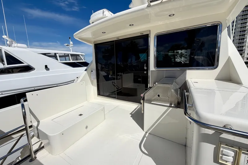 Slide: The Image of Luxury Horizon 92 yacht deck with seating and grill under clear blue sky. - 122